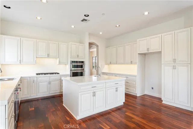 a kitchen with a stove a sink and a refrigerator