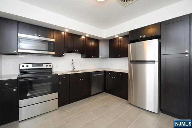 a kitchen with a refrigerator and a stove