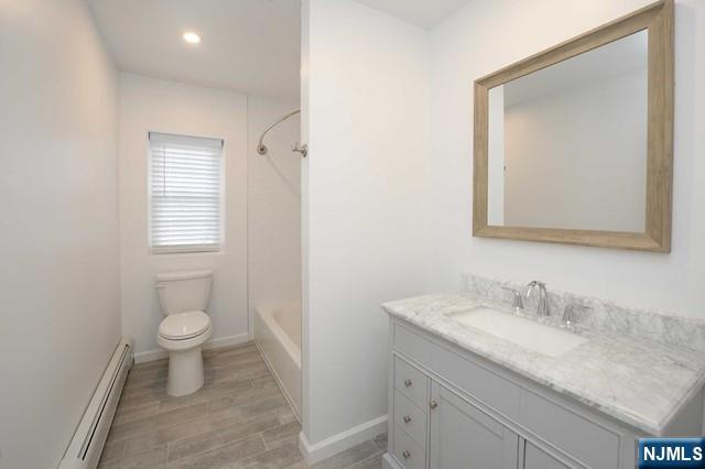 20-30 Ridge Road, Unit A5 Ridgewood, NJ 07450 - Photo 11 of 26 a bathroom with a granite countertop sink a toilet and a mirror