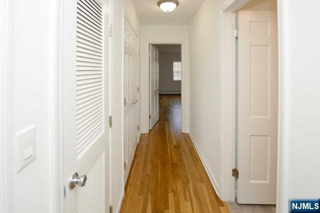 20-30 Ridge Road, Unit A5 Ridgewood, NJ 07450 - Photo 12 of 26 a view of a hallway with wooden floor and staircase