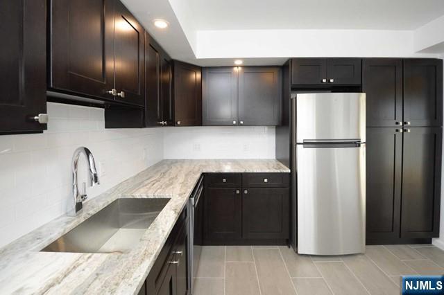 20-30 Ridge Road, Unit A5 Ridgewood, NJ 07450 - Photo 2 of 26 a kitchen with a refrigerator and a sink