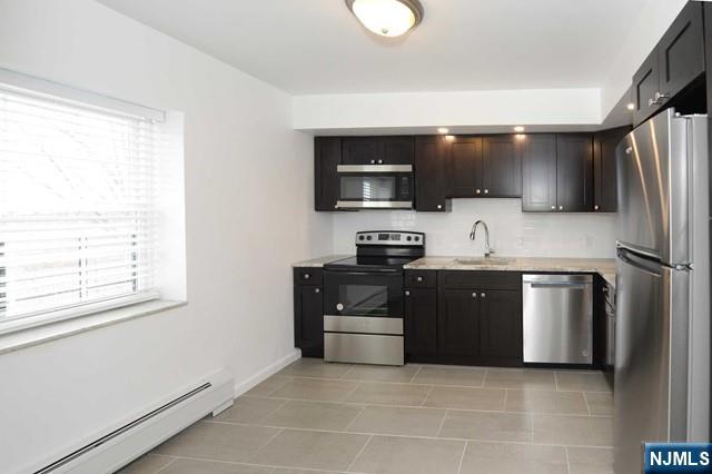 20-30 Ridge Road, Unit A5 Ridgewood, NJ 07450 - Photo 3 of 26 a kitchen with stainless steel appliances a stove a sink and a microwave