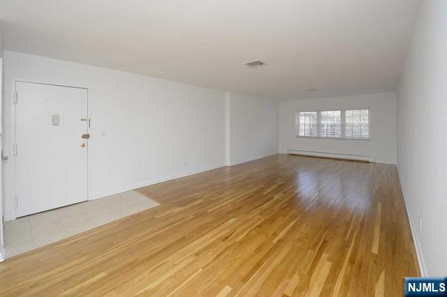 20-30 Ridge Road, Unit A5 Ridgewood, NJ 07450 - Photo 6 of 26 an empty room with wooden floor and windows