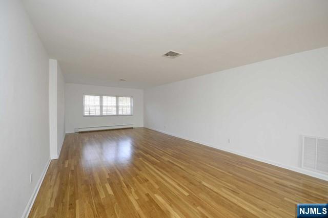 20-30 Ridge Road, Unit A5 Ridgewood, NJ 07450 - Photo 8 of 26 an empty room with wooden floor and windows