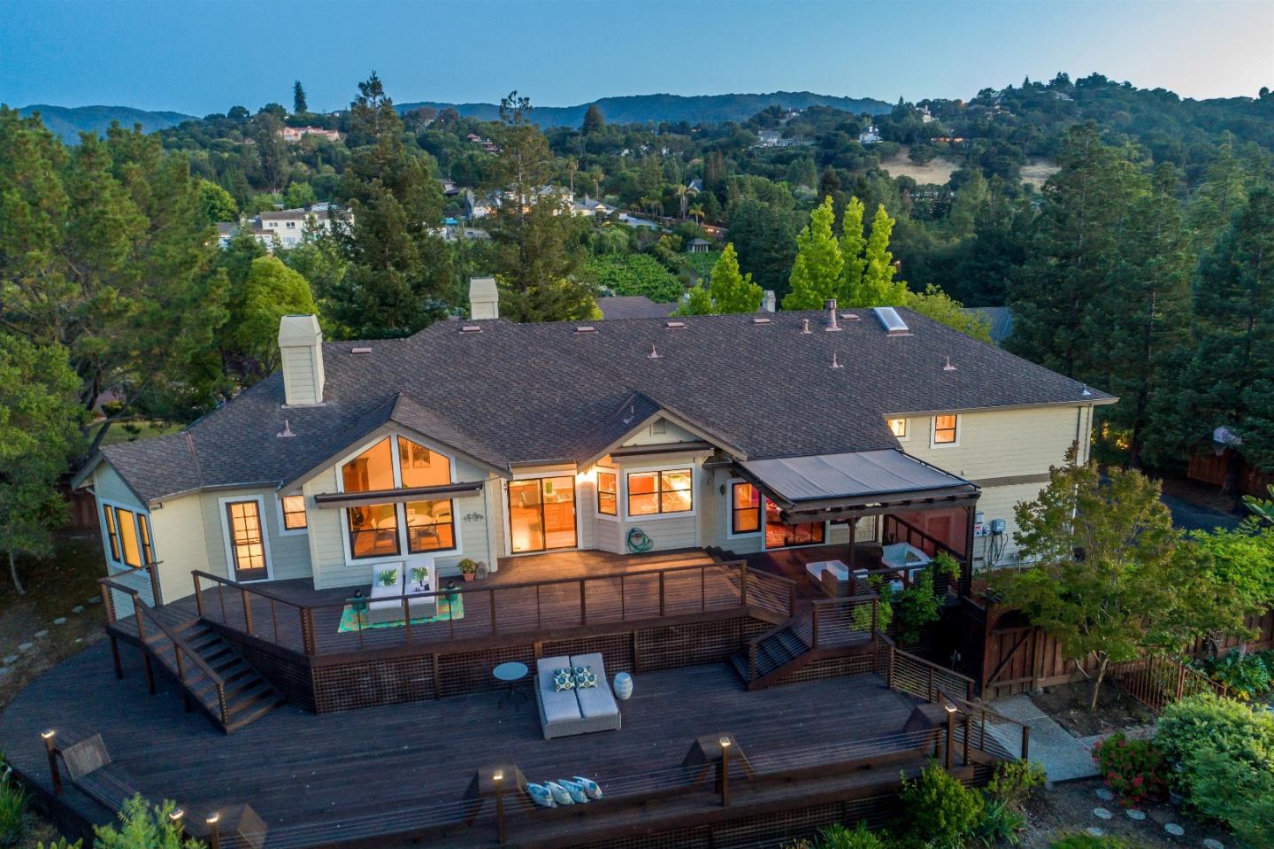 an aerial view of a house with swimming pool patio and outdoor seating