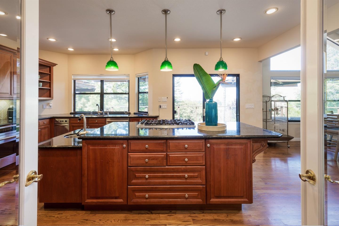 105 Alerche Drive Los Gatos, CA 95032 - Photo 20 of 36 a kitchen with a refrigerator and wooden floor