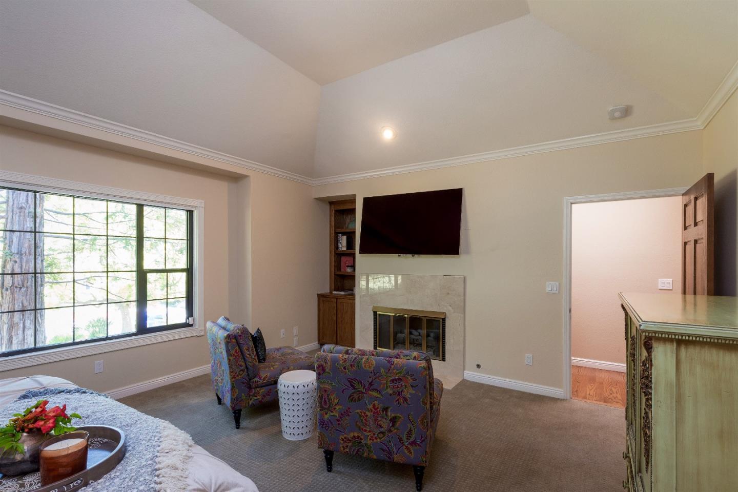 105 Alerche Drive Los Gatos, CA 95032 - Photo 23 of 36 a living room with furniture a flat screen tv and a fireplace