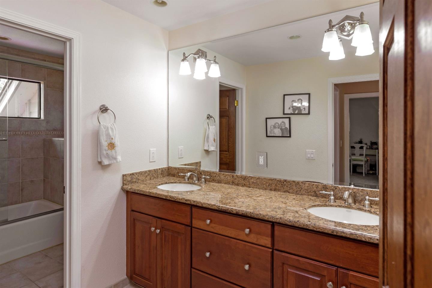 105 Alerche Drive Los Gatos, CA 95032 - Photo 28 of 36 a bathroom with a granite countertop sink and a mirror