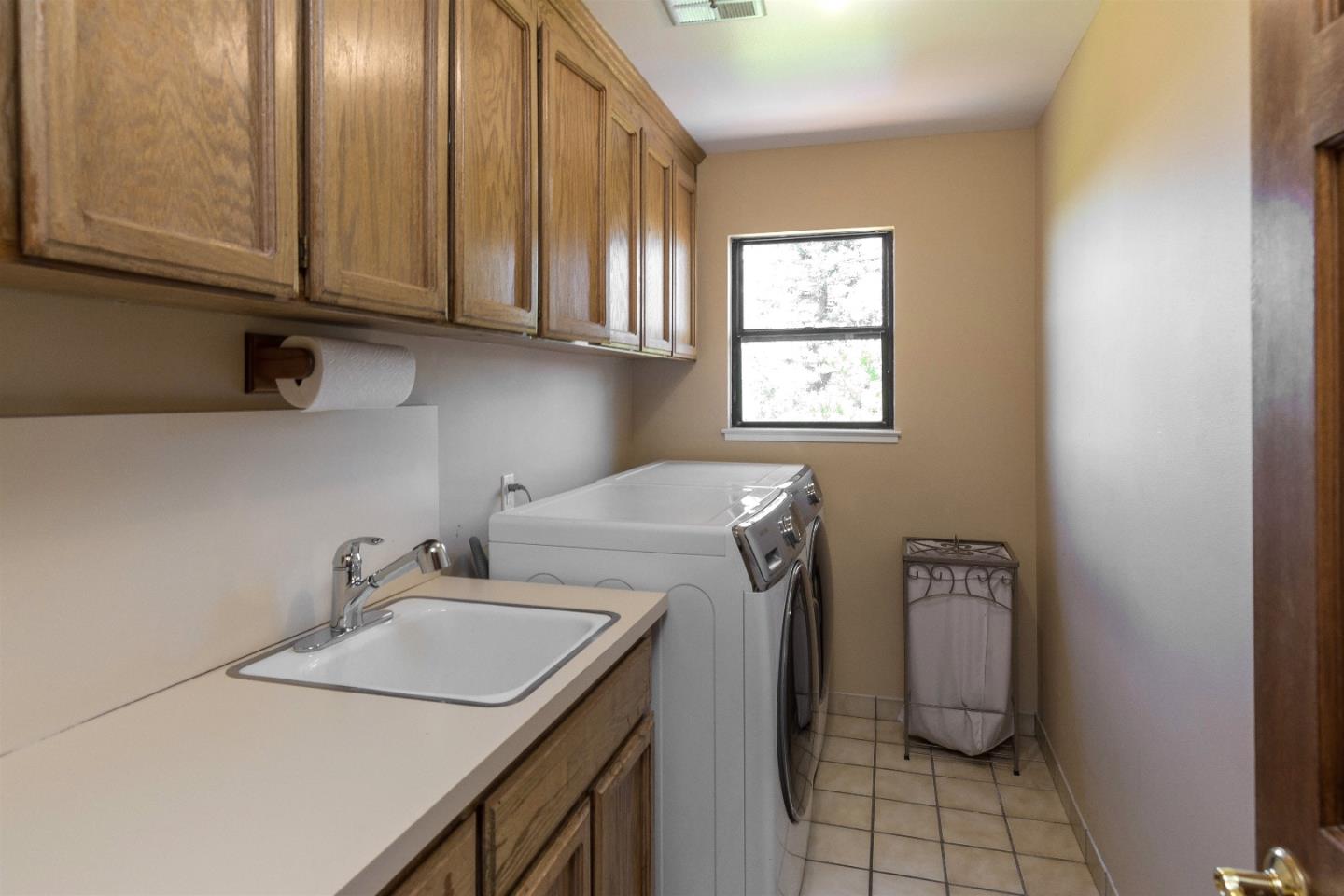 105 Alerche Drive Los Gatos, CA 95032 - Photo 30 of 36 a utility room with a sink a washer and dryer