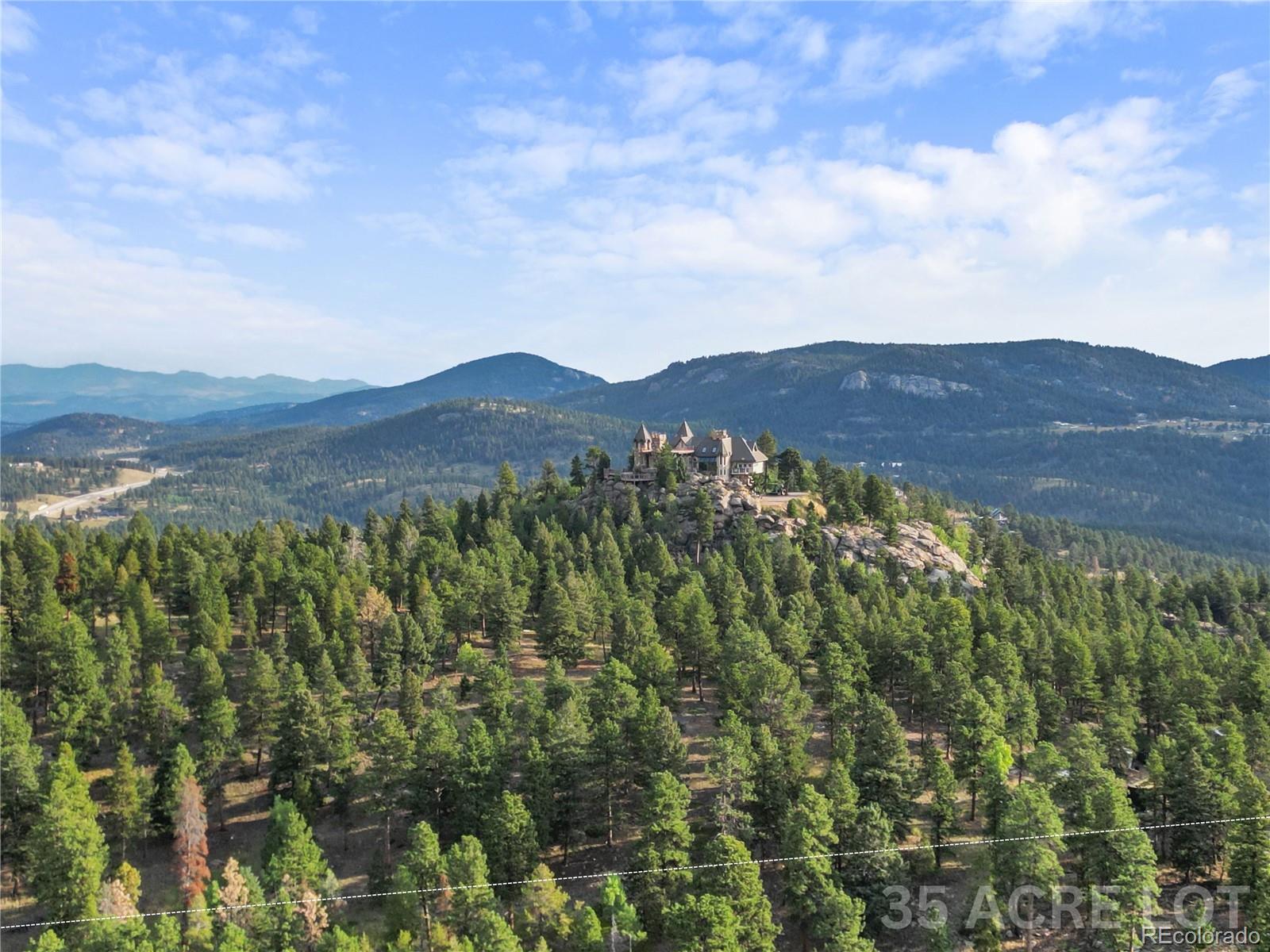 26541 Richmond Hill Road Conifer, CO 80433 - Photo 5 of 27 a view of a mountain range with lush green forest