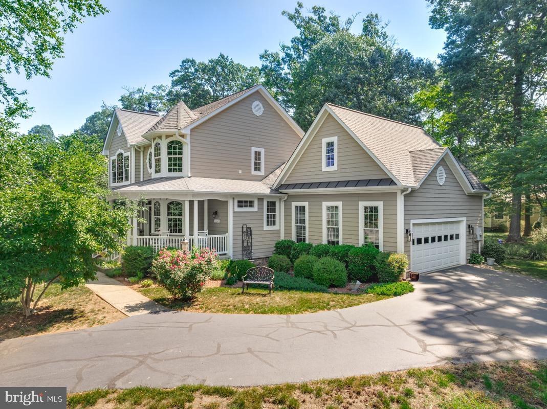11565 Magnolia Court Issue, MD 20645 - Photo 45 of 68 a front view of a house with a yard and potted plants