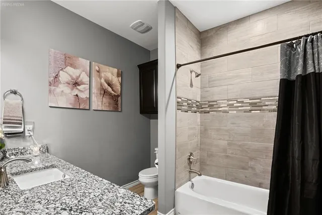 a bathroom with a bathtub a shower and a toilet