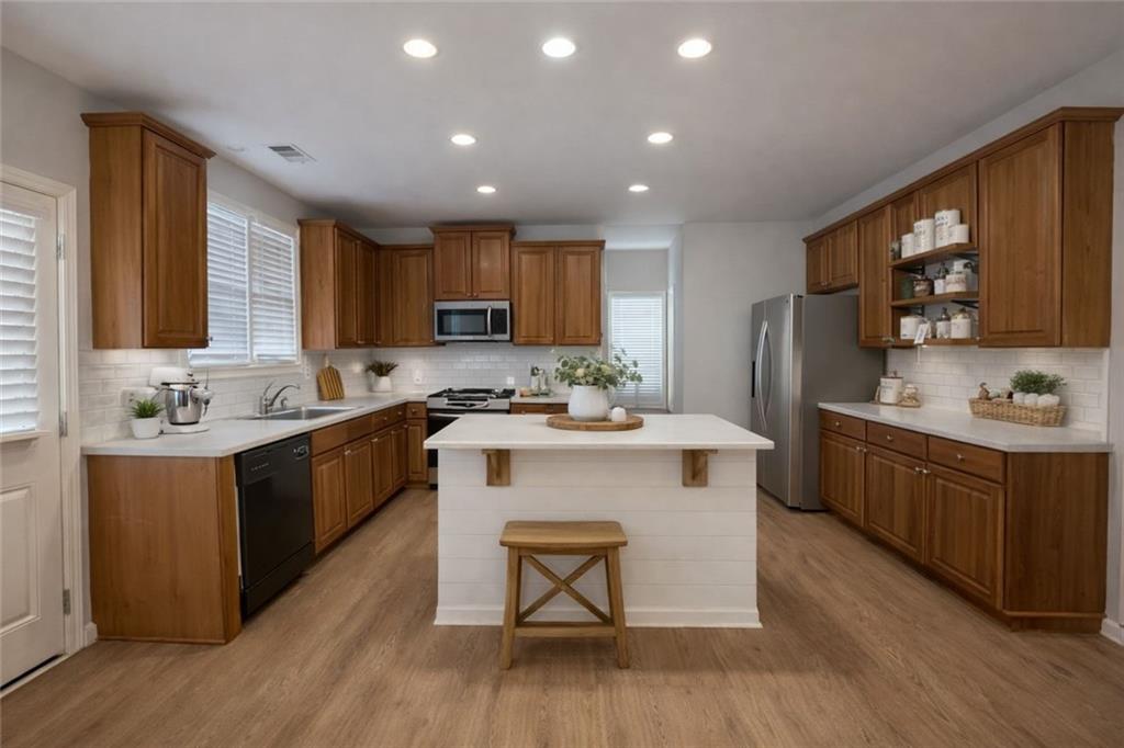 915 Bishops Crossing Norcross, GA 30071 - Photo 3 of 10 a kitchen with a sink cabinets and wooden floor