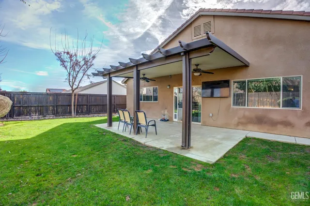 a view of a house with a yard and sitting area