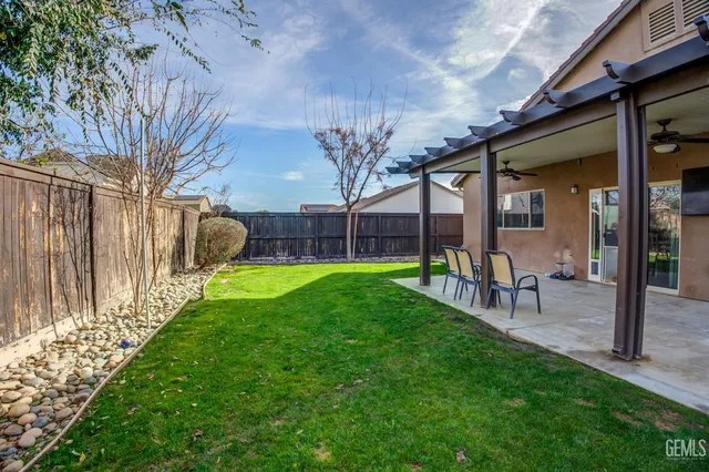 a view of a house with a backyard porch and sitting area