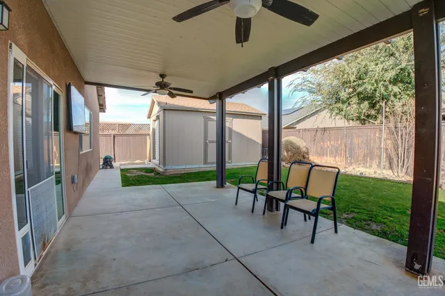 a view of a porch with chairs and backyard