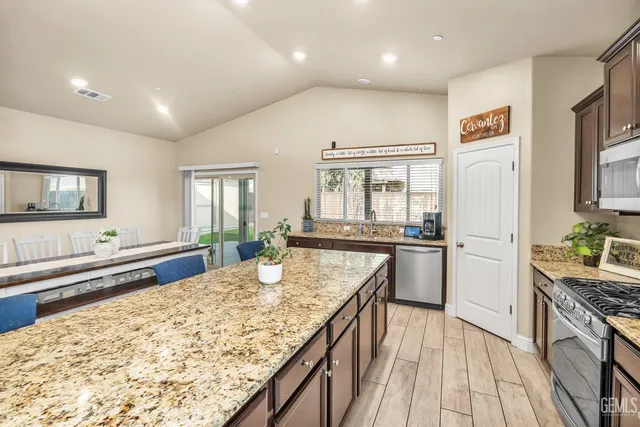 a kitchen with refrigerator cabinets and wooden floor