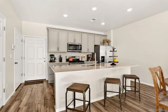 a kitchen with a sink a stove and cabinets