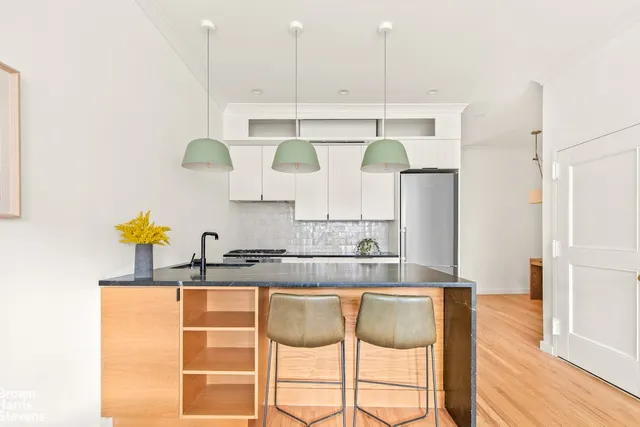 a room that has a table and a dresser in it