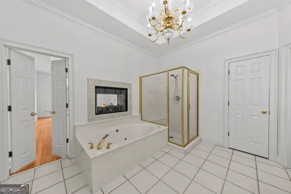 an empty room with windows and ceiling fan