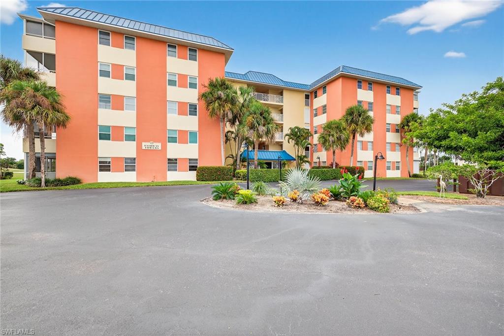 200 Pebble Beach Boulevard, Unit D406 Naples, FL 34113 - Photo 2 of 24 front view of a house with a street