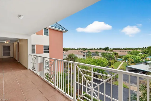 a view of a swimming pool with a yard and plants