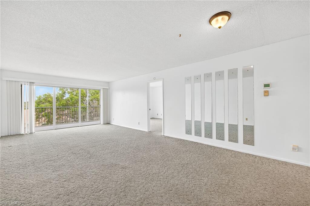200 Pebble Beach Boulevard, Unit D406 Naples, FL 34113 - Photo 6 of 24 a view of an empty room with a window