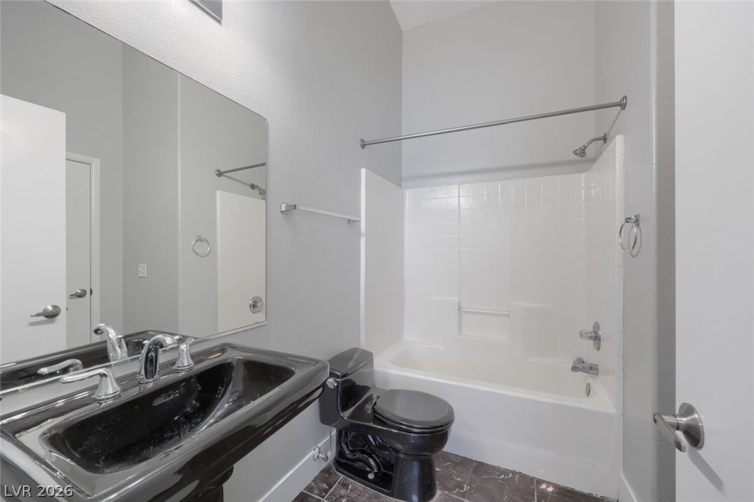 5985 High Steed Street, Unit 101 Henderson, NV 89011 - Photo 28 of 38 A well-appointed bath features a sleek black sink and coordinating commode.