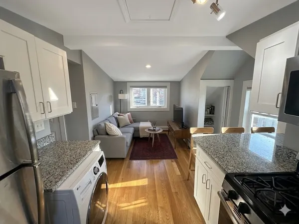 a living room with furniture and a counter top space