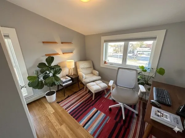 a living room with furniture rug and window