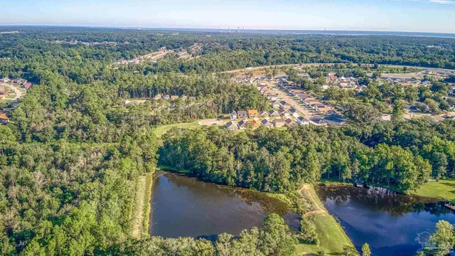 an aerial view of a house with a yard and lake view