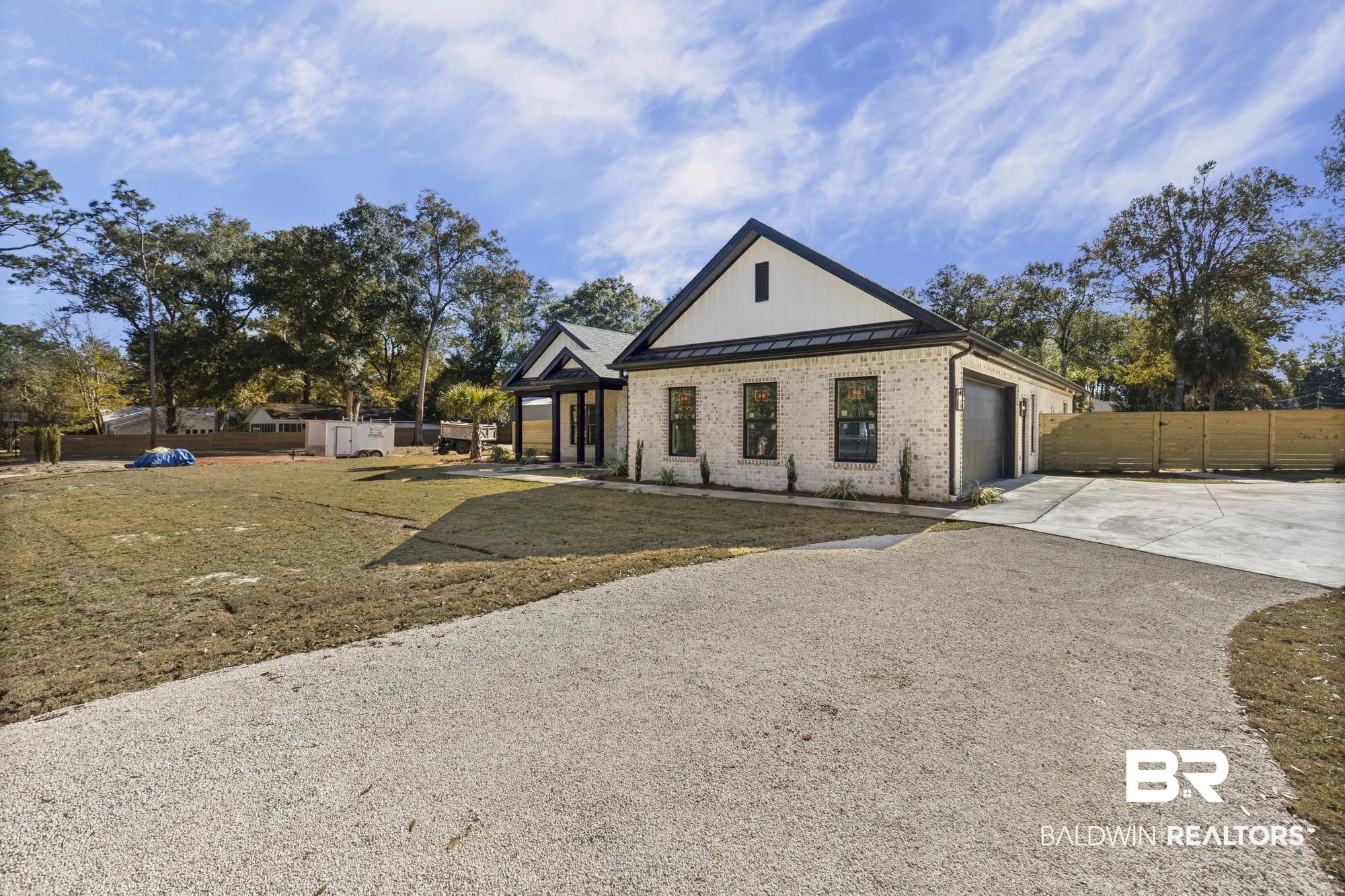 10180 Pineview Drive Foley, AL 36535 - Photo 9 of 47 Modern inspired farmhouse with a standing seam roof, concrete driveway, a metal roof, brick siding, and a garage