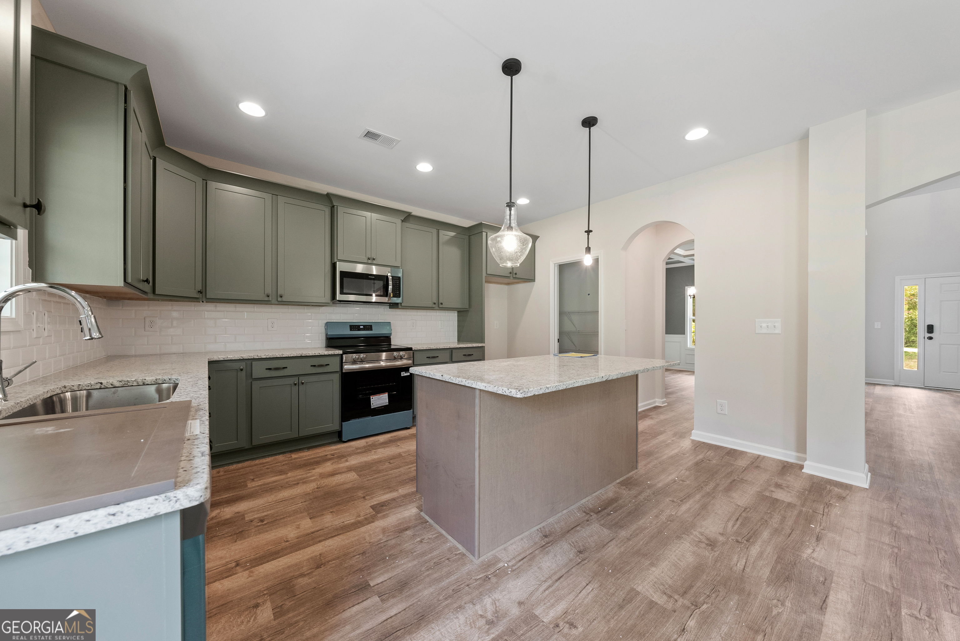 575 Bohannon Road, Unit 8 Grantville, GA 30220 - Photo 11 of 33 a kitchen with stainless steel appliances granite countertop a sink a stove and a refrigerator