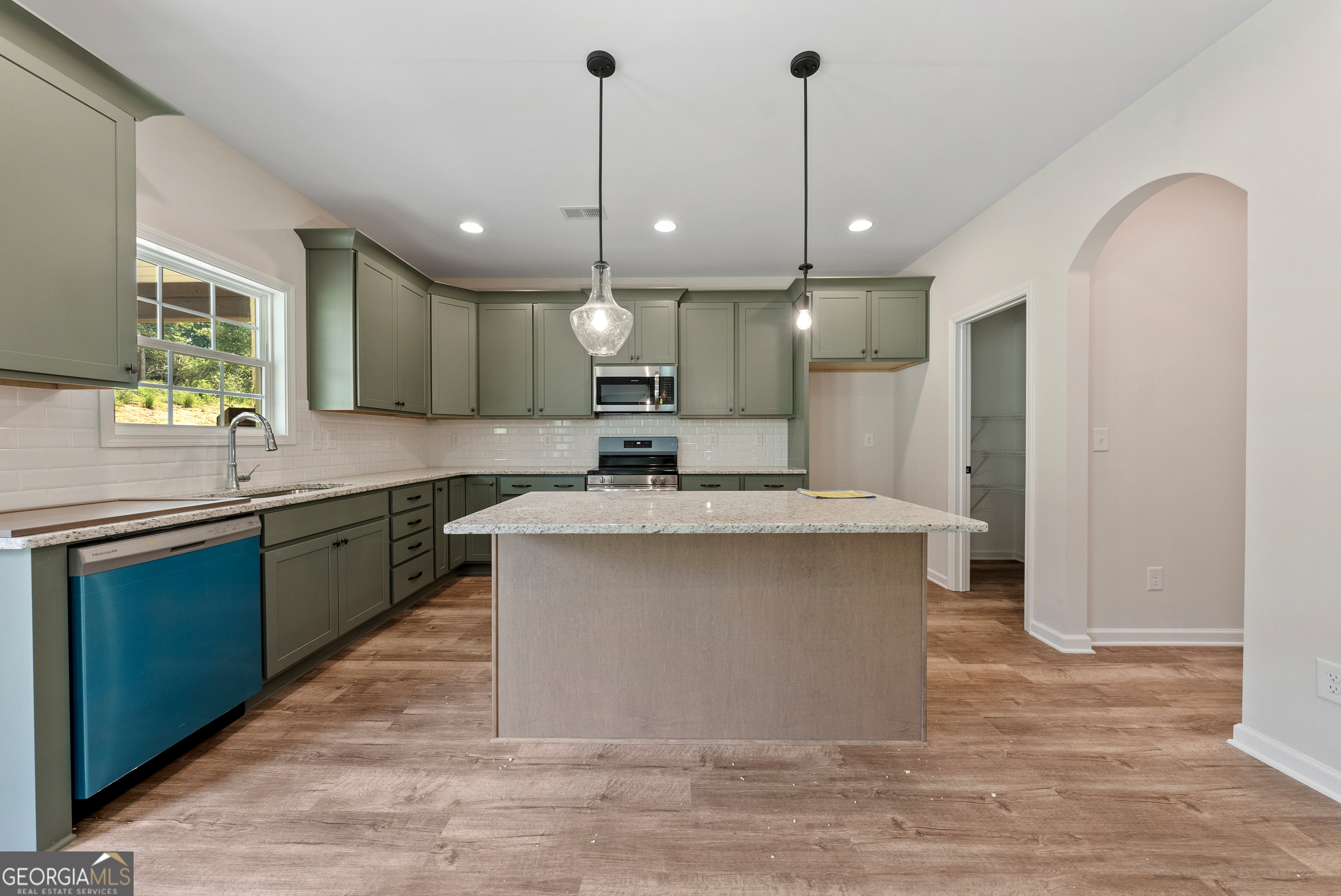 575 Bohannon Road, Unit 8 Grantville, GA 30220 - Photo 12 of 33 a large kitchen with a large counter top a sink stainless steel appliances and cabinets