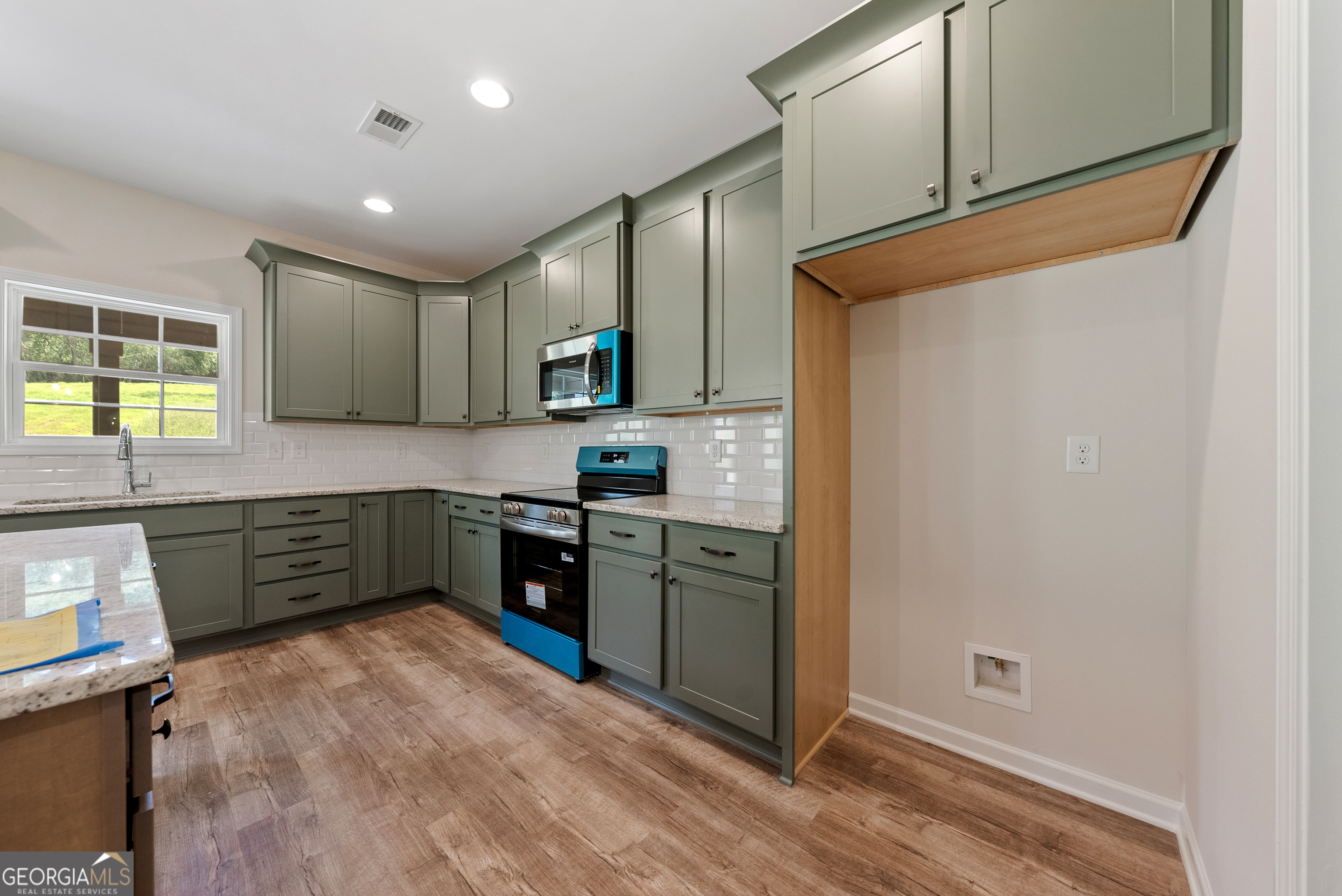 575 Bohannon Road, Unit 8 Grantville, GA 30220 - Photo 9 of 33 a kitchen with a refrigerator and a stove top oven