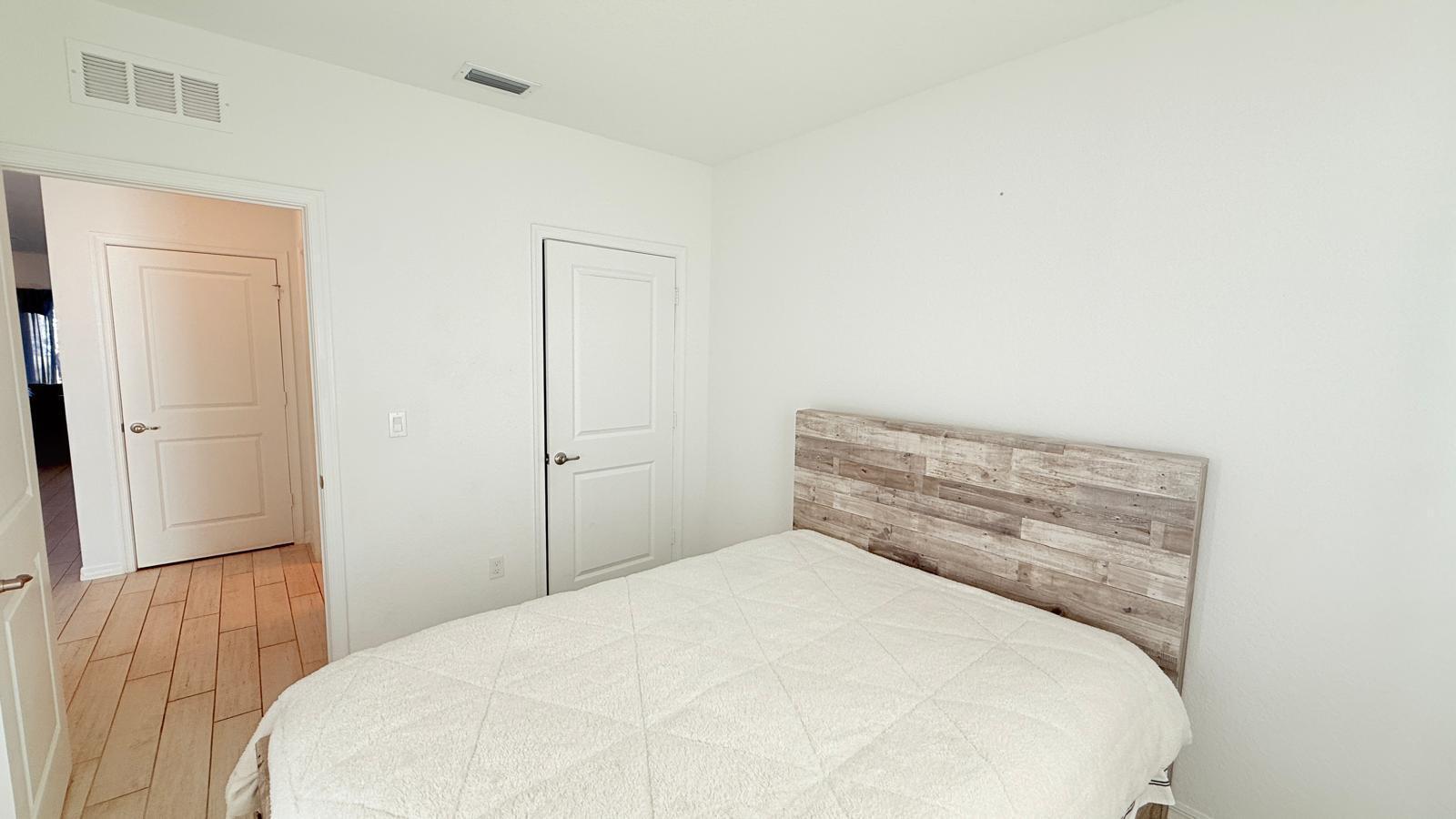 5154 Armina Place Fort Pierce, FL 34951 - Photo 20 of 38 a bedroom with a bed and a wooden floor