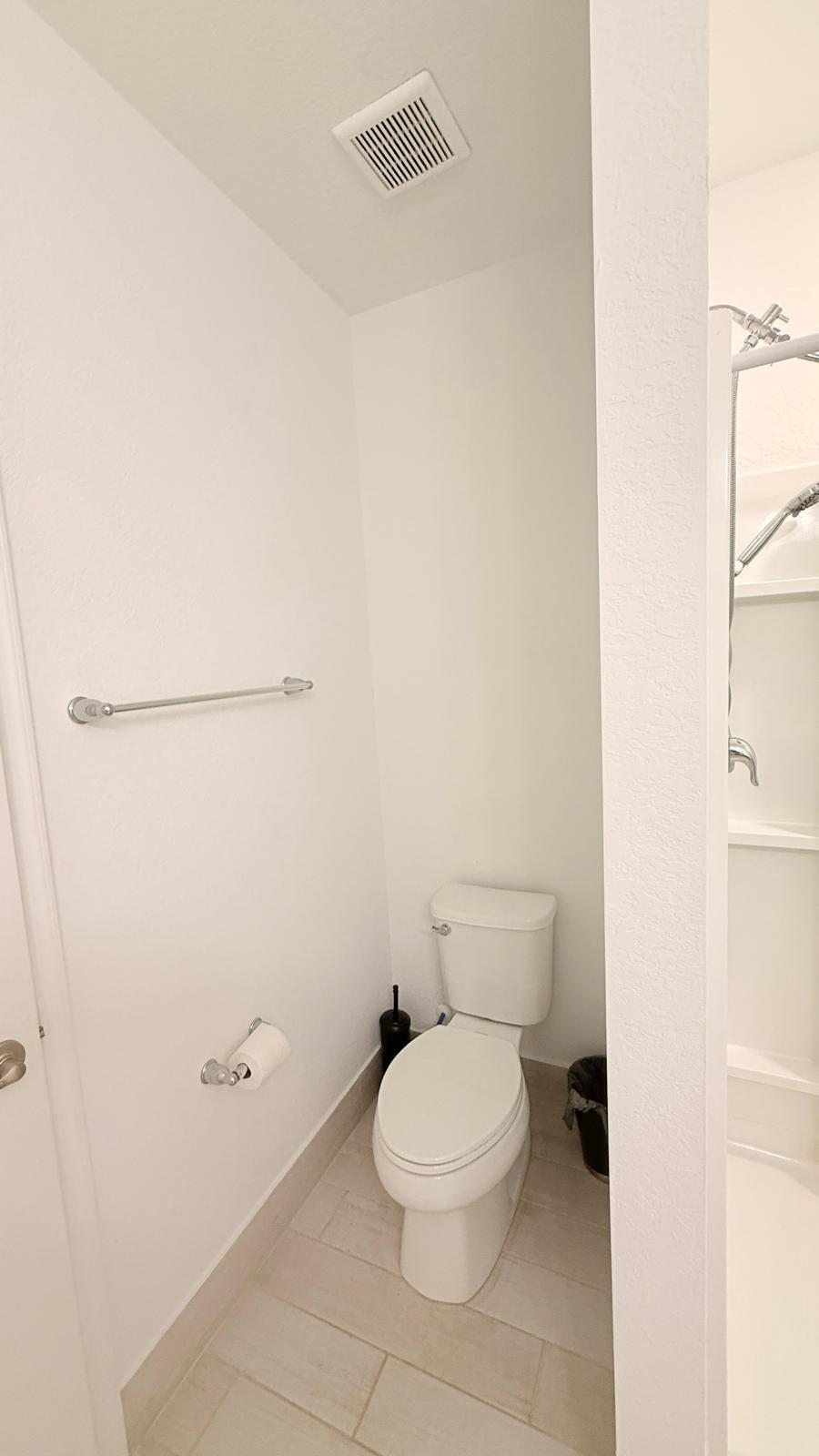 5154 Armina Place Fort Pierce, FL 34951 - Photo 33 of 38 a white toilet sitting next to a white sink and vanity