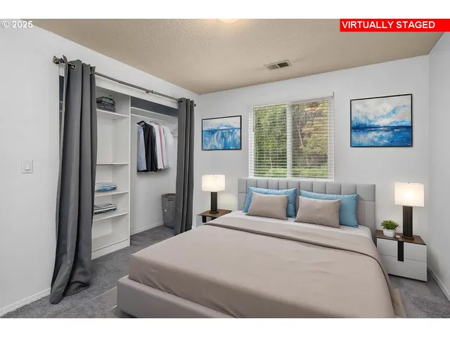 a bedroom with a bed and a painting on the wall