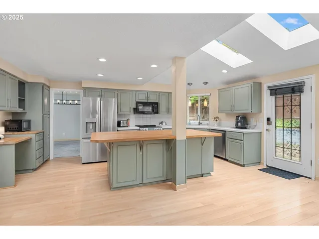 a kitchen with a sink cabinets and stainless steel appliances