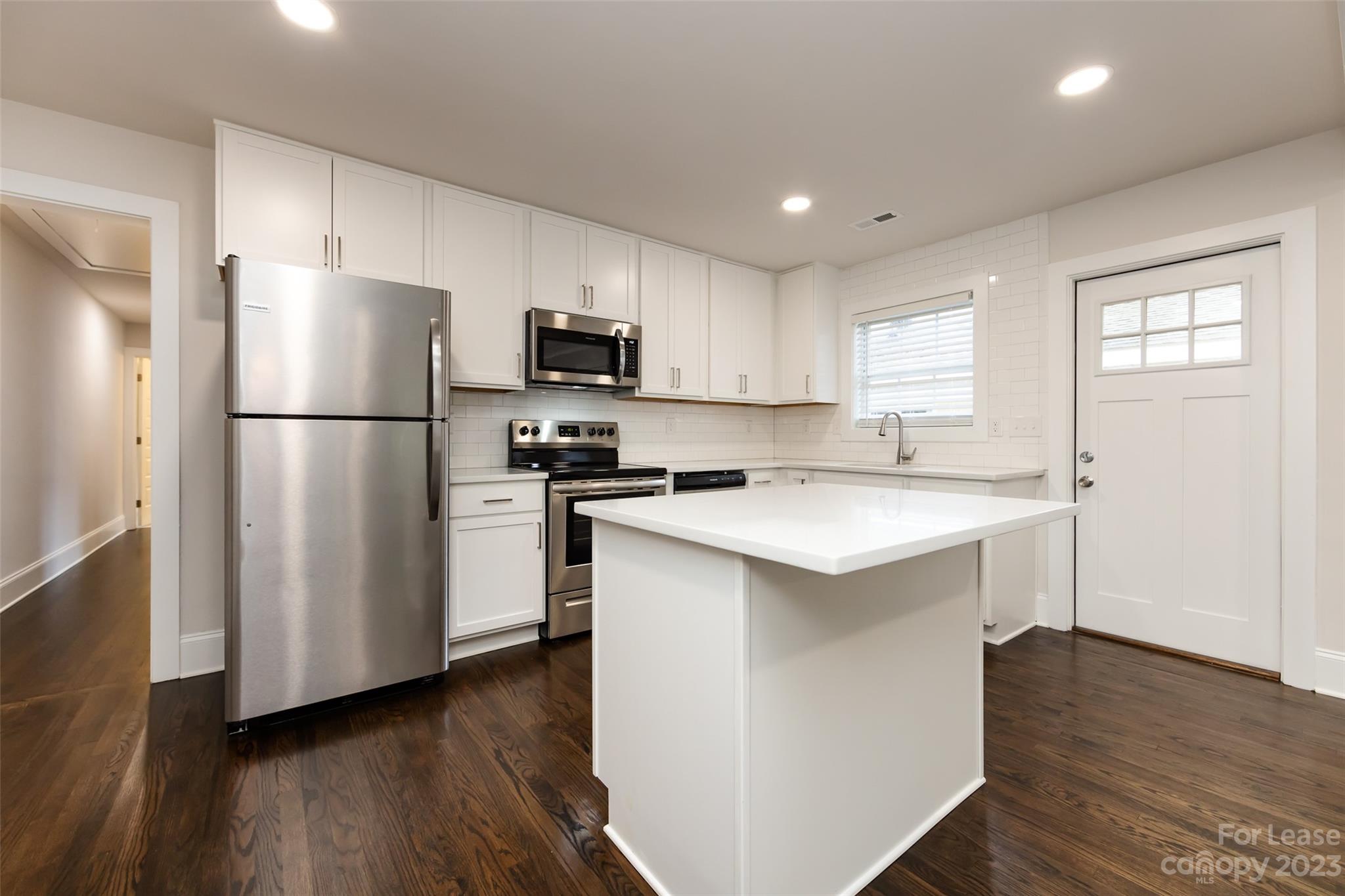 1704 Club Road, Unit A Charlotte, NC 28205 - Photo 14 of 35 a kitchen with a refrigerator a sink and a stove top oven