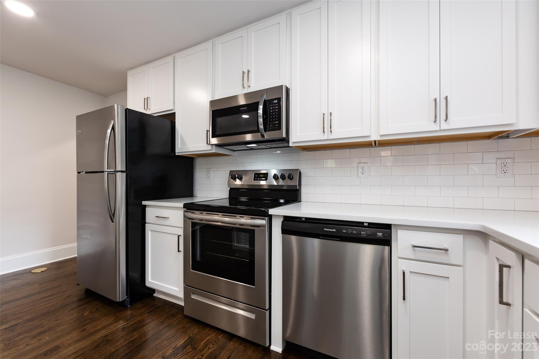 1704 Club Road, Unit A Charlotte, NC 28205 - Photo 15 of 35 a kitchen with white cabinets and stainless steel appliances