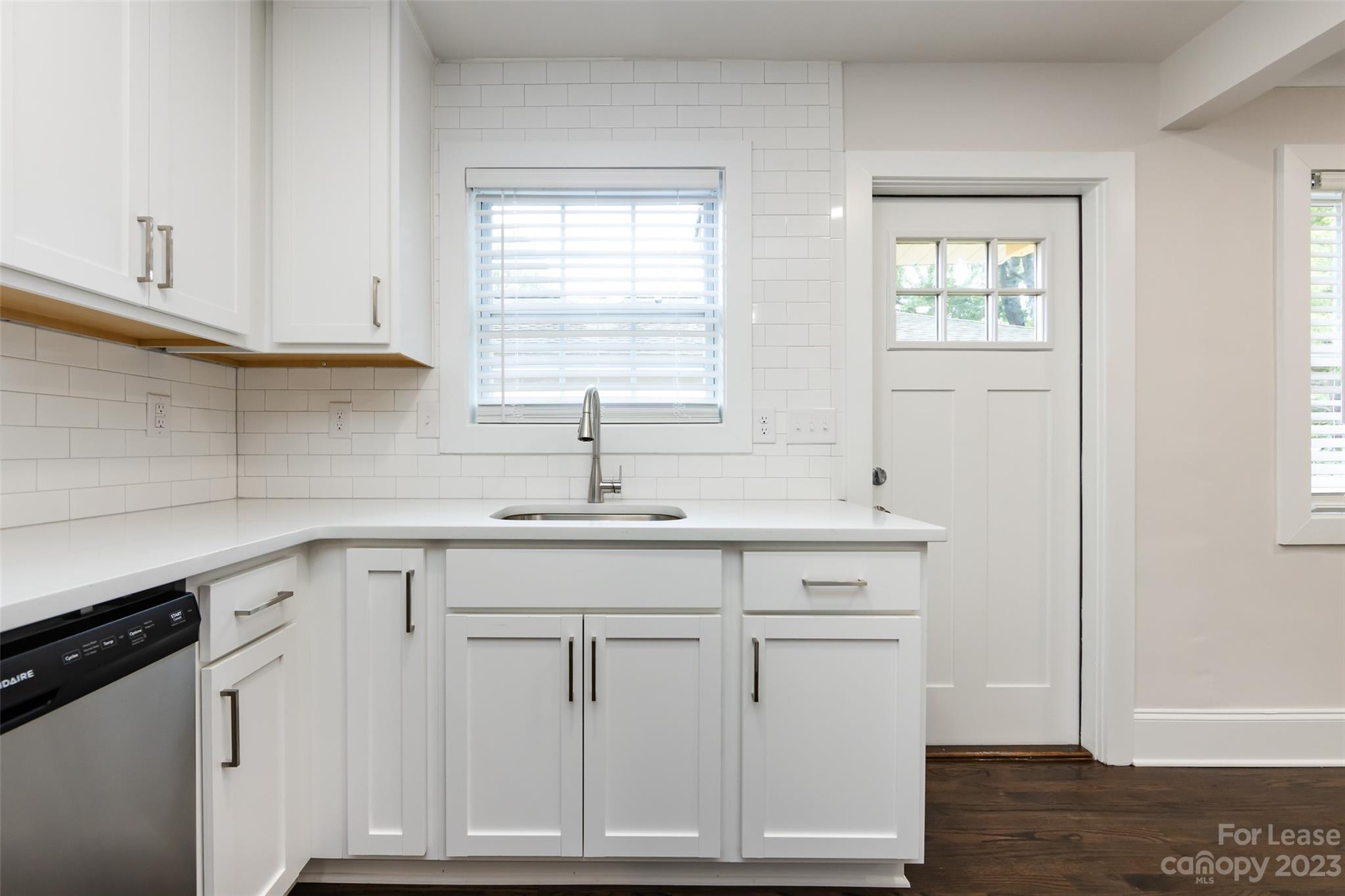1704 Club Road, Unit A Charlotte, NC 28205 - Photo 17 of 35 a kitchen with white cabinets and sink
