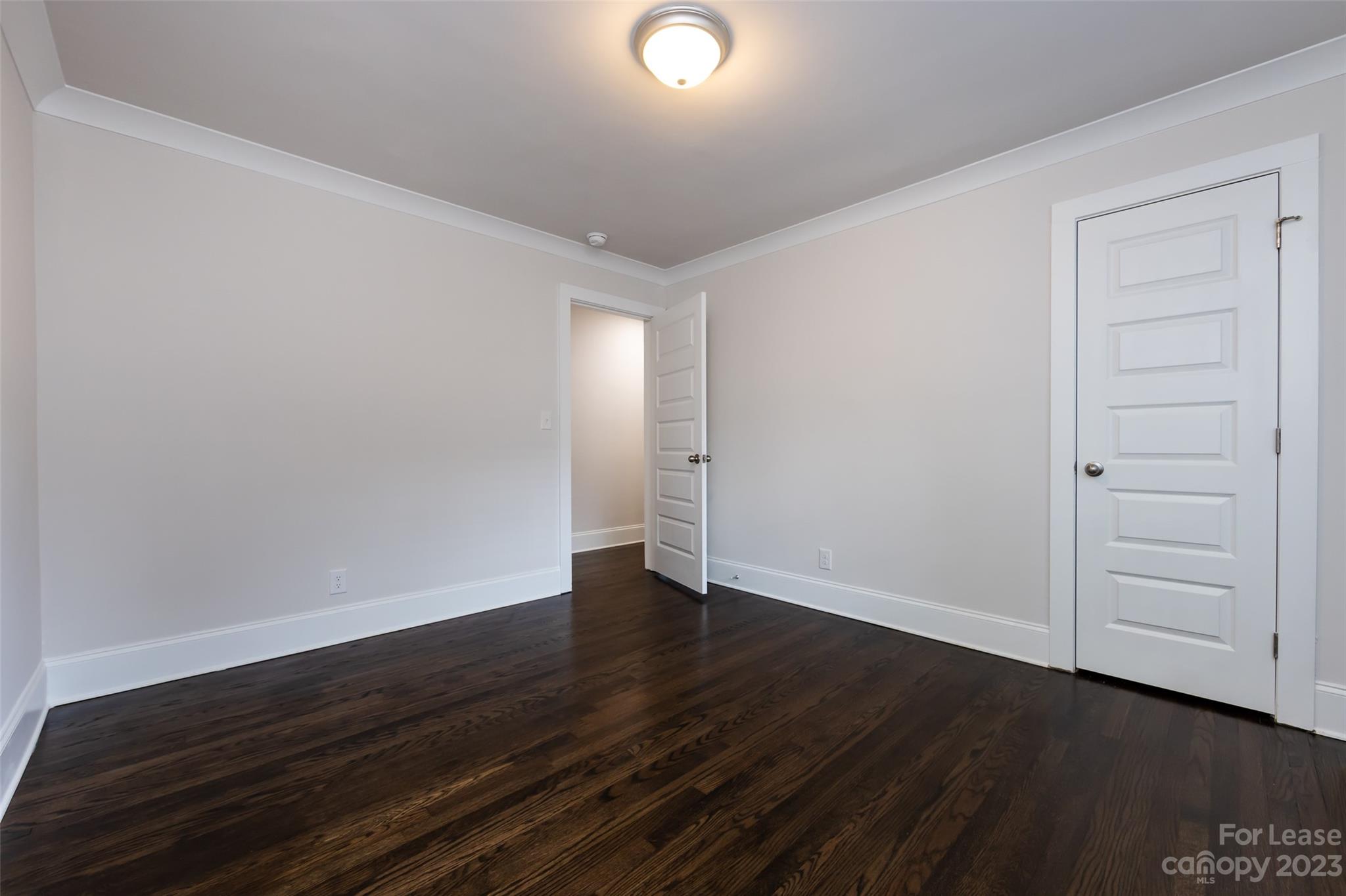 1704 Club Road, Unit A Charlotte, NC 28205 - Photo 25 of 35 a view of an empty room with wooden floor