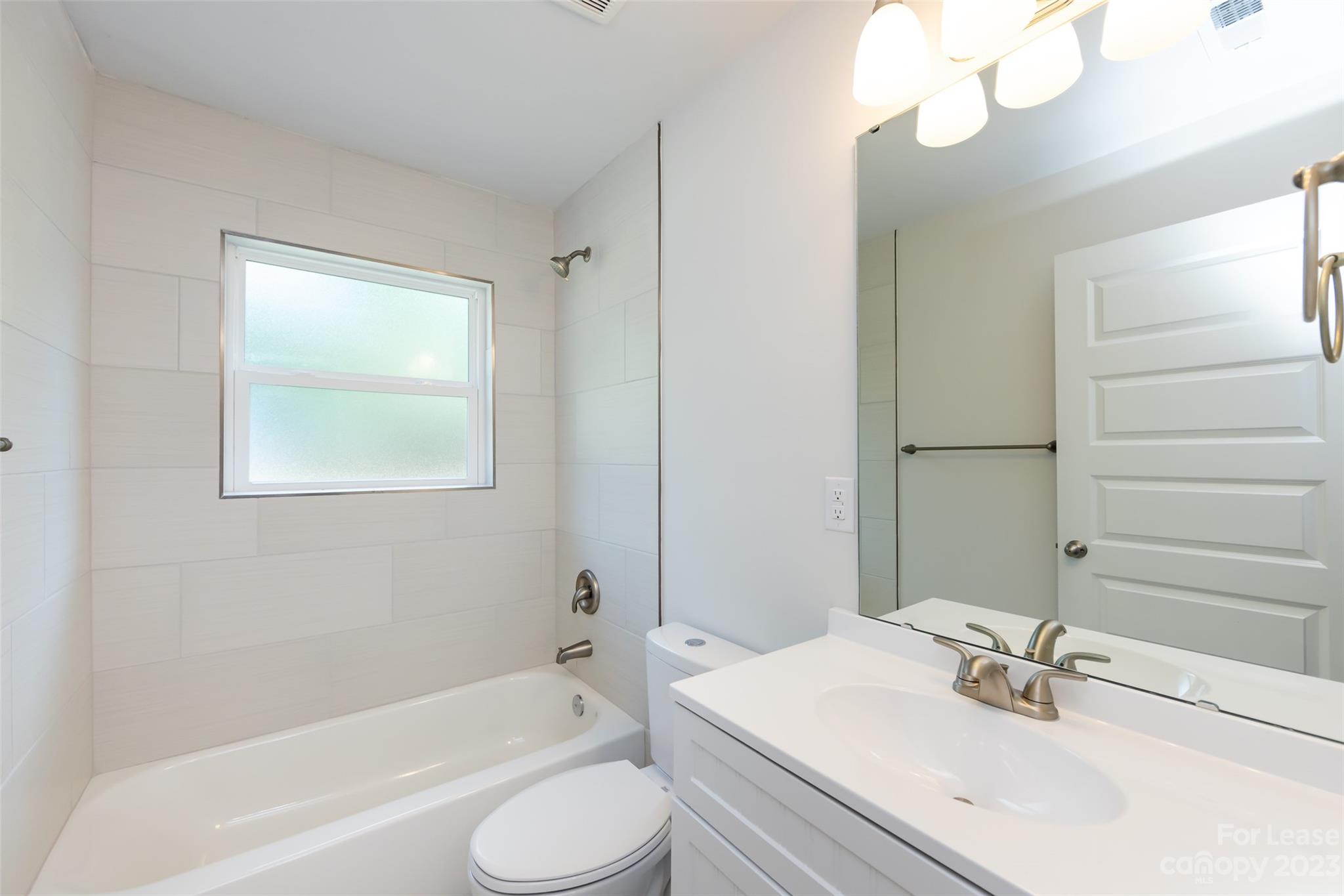 1704 Club Road, Unit A Charlotte, NC 28205 - Photo 26 of 35 a bathroom with a sink a toilet and shower