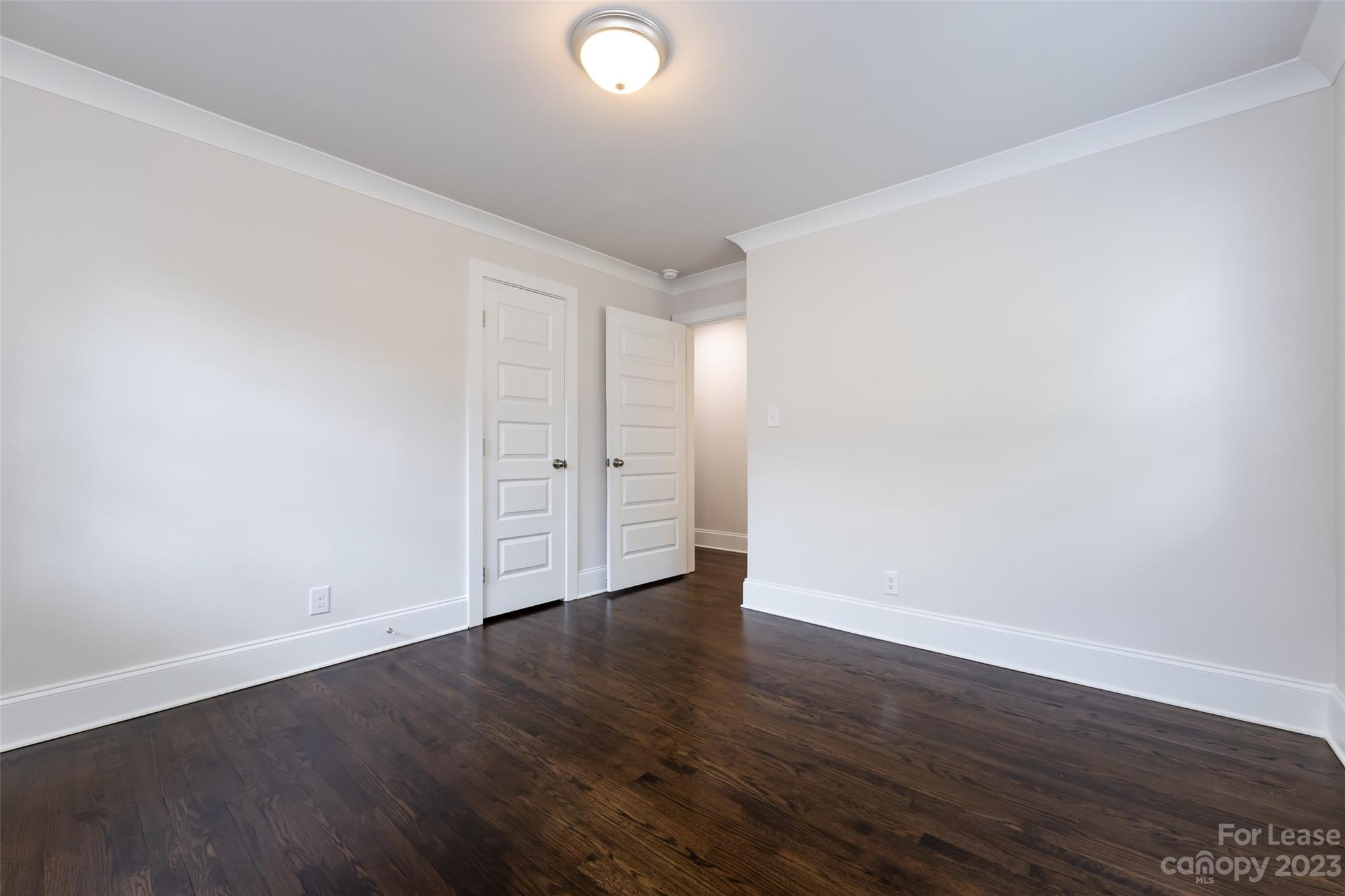 1704 Club Road, Unit A Charlotte, NC 28205 - Photo 27 of 35 an empty room with wooden floor