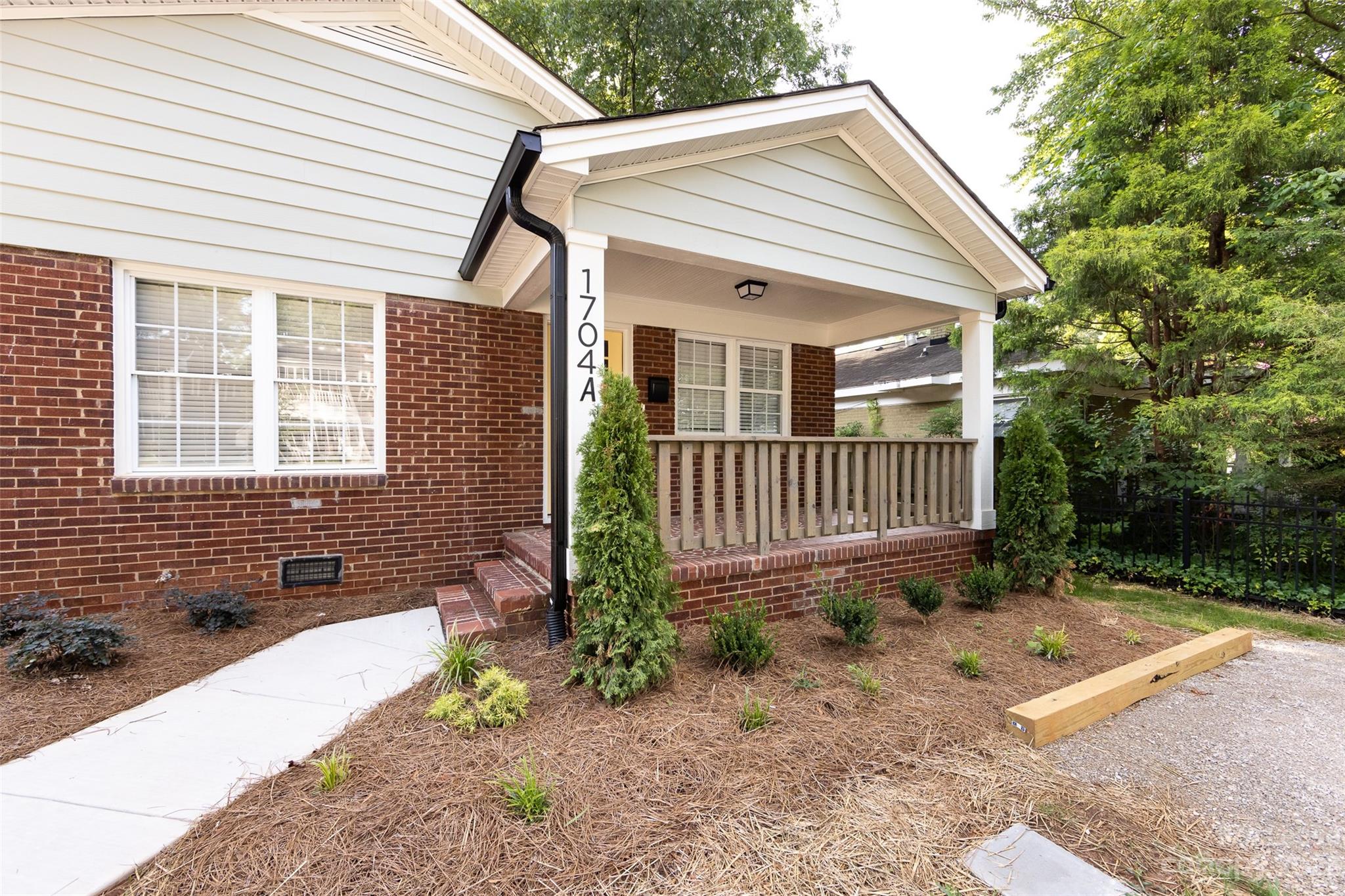 1704 Club Road, Unit A Charlotte, NC 28205 - Photo 4 of 35 a front view of a house with a yard