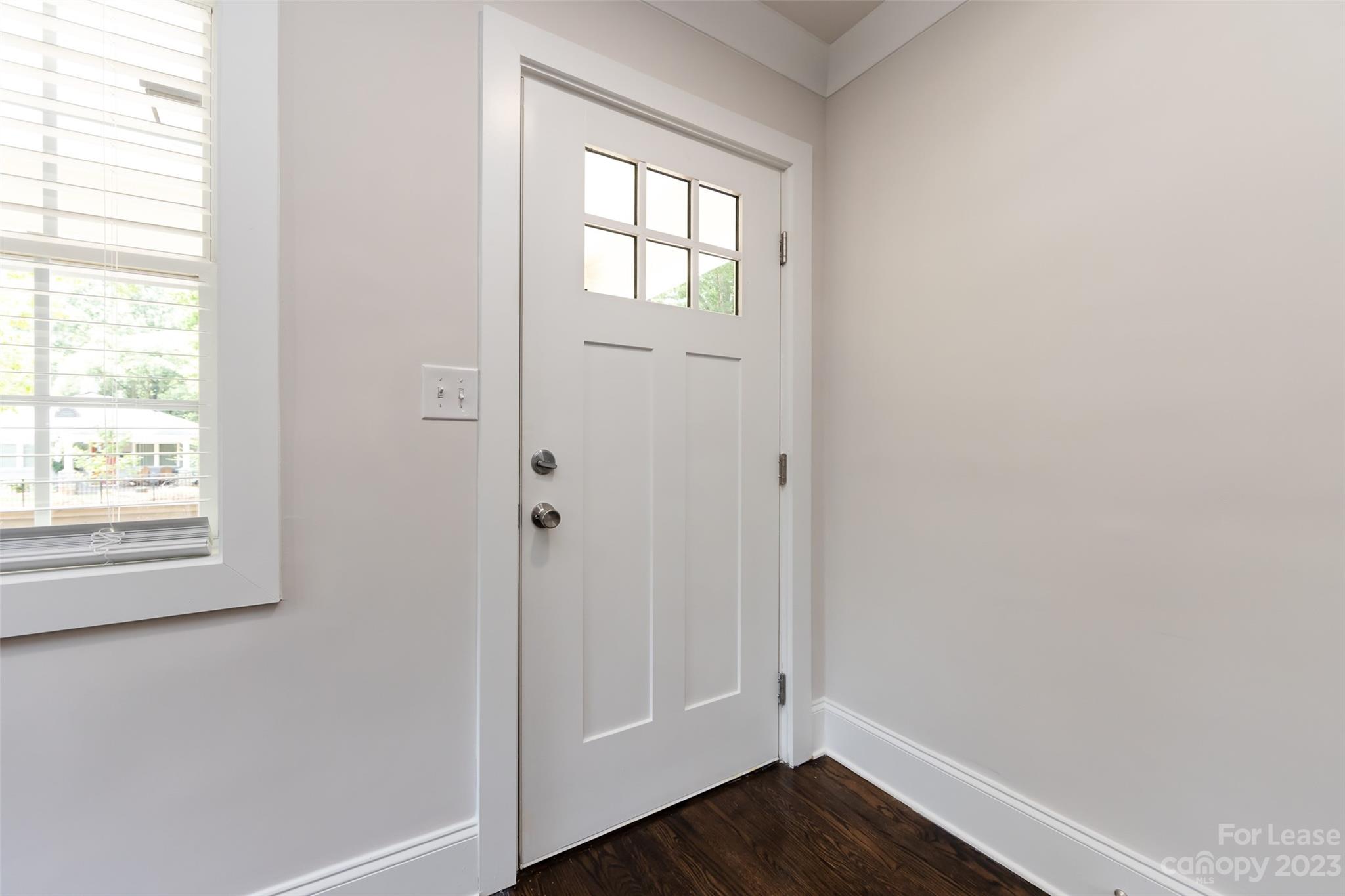 1704 Club Road, Unit A Charlotte, NC 28205 - Photo 7 of 35 an empty room with wooden floor and window