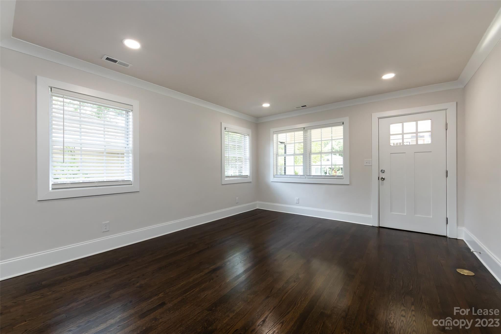 1704 Club Road, Unit A Charlotte, NC 28205 - Photo 8 of 35 an empty room with wooden floor and windows