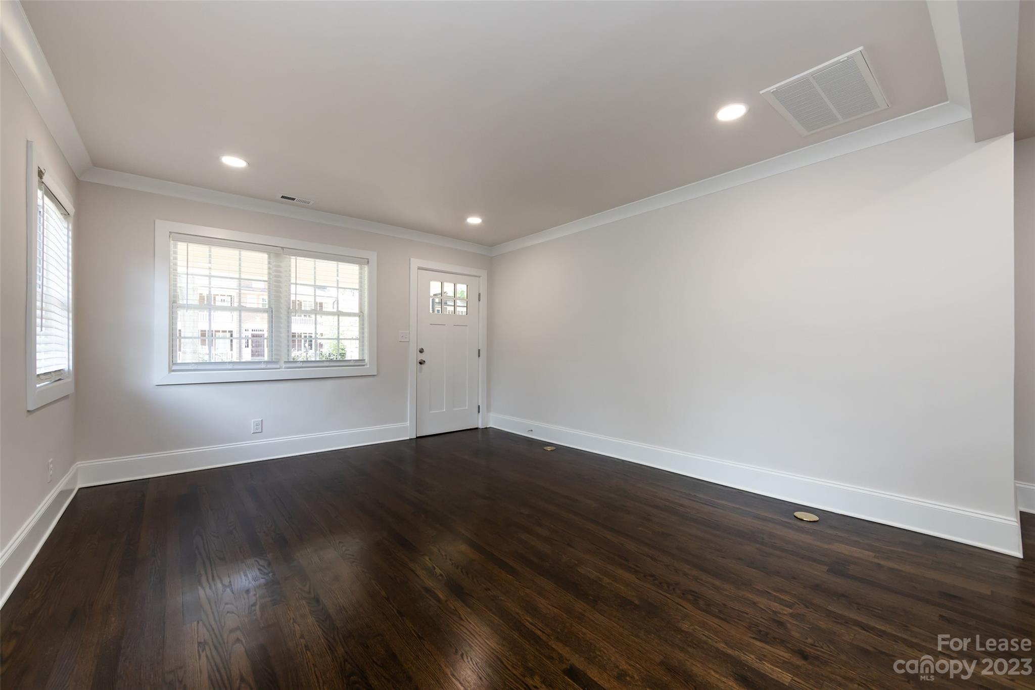 1704 Club Road, Unit A Charlotte, NC 28205 - Photo 9 of 35 an empty room with wooden floor and windows