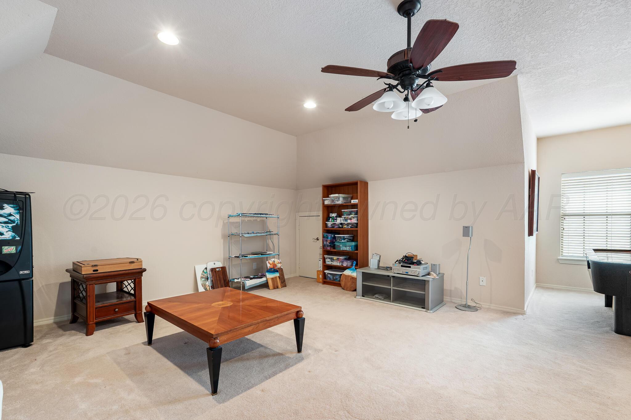 5008 Wesley Road Amarillo, TX 79119 - Photo 19 of 47 a living room with furniture a ceiling fan and a rug